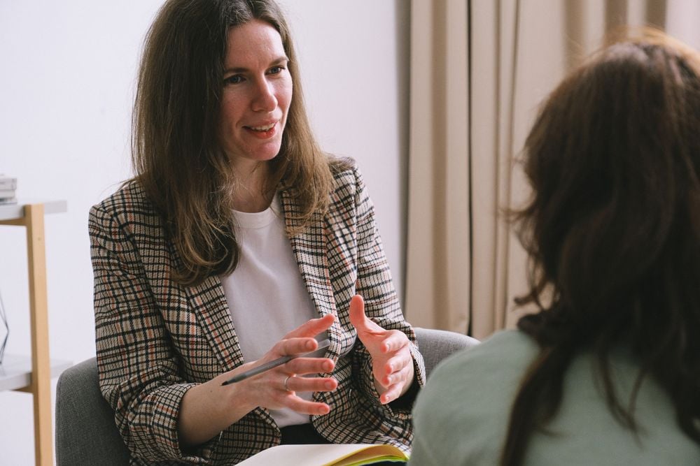 Client and licensed therapist discussing goals during a counseling session
