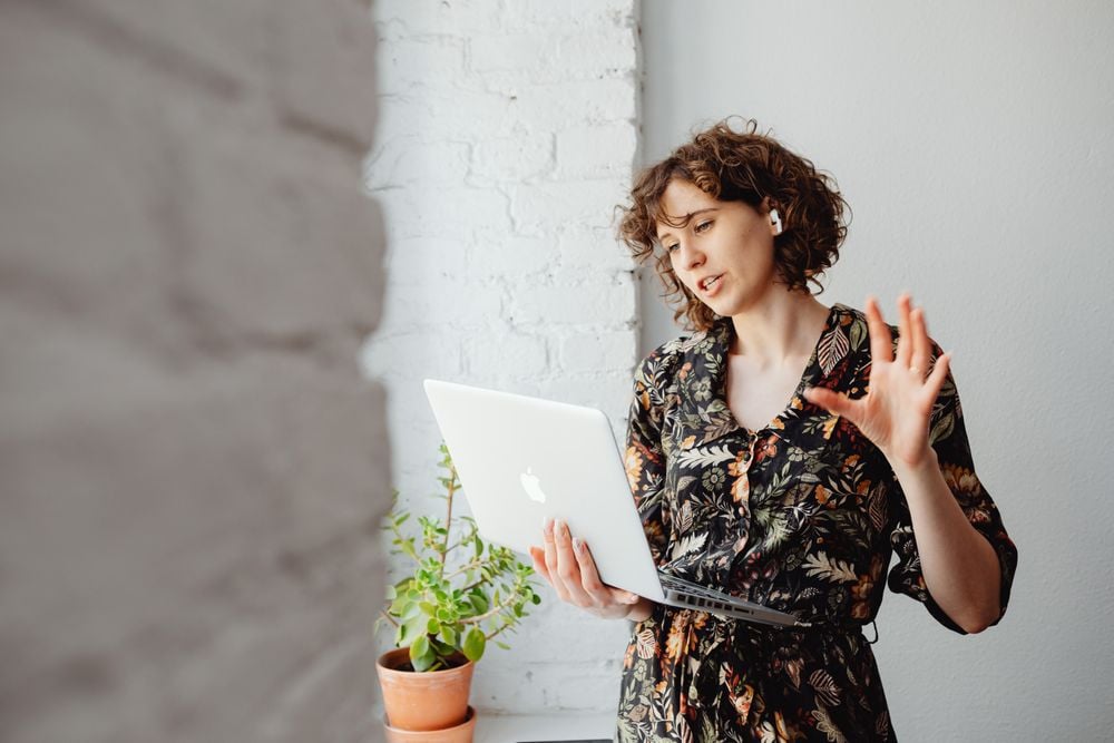Woman attending an online therapy session on her laptop from home