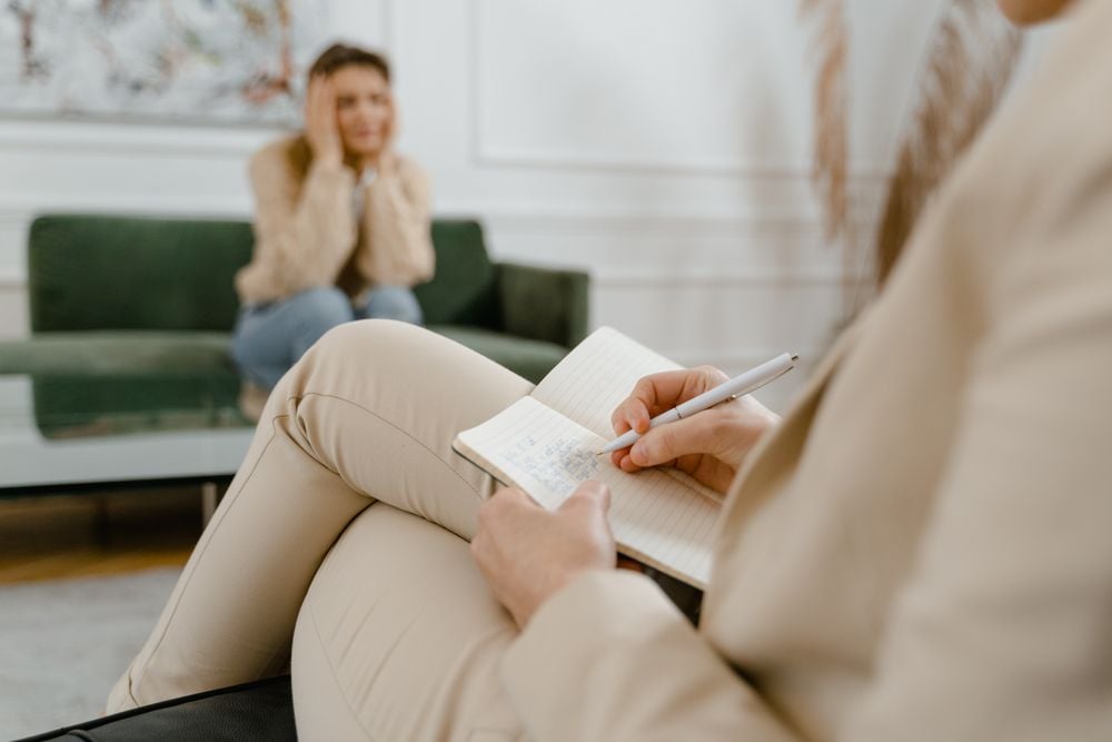 Therapist supporting a client through a difficult, emotional conversation