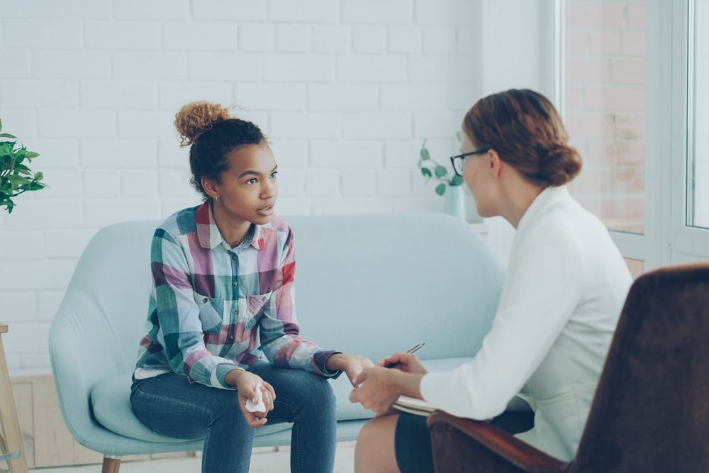 Behavioral therapist talking with a child client during a counseling session
