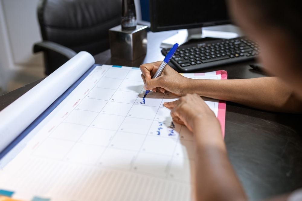 Person checking a calendar while planning their next therapy appointment